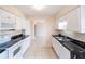 Spacious kitchen with white appliances, tile floor and dark countertops at 536 Lakehurst Nw Ave, Port Charlotte, FL 33952