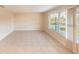 Spacious living room with tile flooring and large windows offering abundant natural light at 536 Lakehurst Nw Ave, Port Charlotte, FL 33952