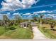 Stunning aerial view of a home with lush landscaping and a spacious driveway at 619 Boundary Blvd, Rotonda West, FL 33947