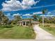 Stunning aerial view of a landscaped home with a well-maintained lawn and palm trees at 619 Boundary Blvd, Rotonda West, FL 33947
