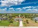 An aerial view of property lines for a home with a big lawn, blue sky, and clouds above at 619 Boundary Blvd, Rotonda West, FL 33947