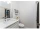 Half bathroom features a white vanity and modern sink with black and white decor at 619 Boundary Blvd, Rotonda West, FL 33947