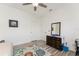 Bright bedroom with ceiling fan, wooden floors, area rug, and dresser at 619 Boundary Blvd, Rotonda West, FL 33947