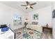 Cozy bedroom with ceiling fan, area rug, and natural light streaming in at 619 Boundary Blvd, Rotonda West, FL 33947