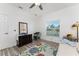 Bright bedroom with ceiling fan, wooden floors, area rug, dresser, and natural light at 619 Boundary Blvd, Rotonda West, FL 33947