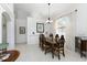 Bright dining area features neutral paint, pendant lighting, decorative archways, and classic wood dining set at 619 Boundary Blvd, Rotonda West, FL 33947