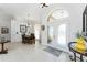 Bright foyer featuring neutral paint, light tile flooring, decorative mirror, and dining room view at 619 Boundary Blvd, Rotonda West, FL 33947
