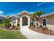 Beautiful home featuring a well-manicured lawn, mature landscaping, and a welcoming entrance at 619 Boundary Blvd, Rotonda West, FL 33947