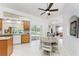 Bright kitchen with light wood cabinets, granite counters, breakfast nook, and sliding glass doors to patio at 619 Boundary Blvd, Rotonda West, FL 33947