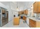 Spacious kitchen with stainless steel appliances, granite counters, island and light wood cabinets at 619 Boundary Blvd, Rotonda West, FL 33947