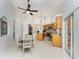 Well-lit kitchen featuring stainless steel appliances, granite counters, a center island, and tile flooring at 619 Boundary Blvd, Rotonda West, FL 33947