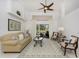 Bright living room with large window, comfortable furniture, and neutral color palette at 619 Boundary Blvd, Rotonda West, FL 33947