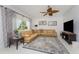 Living room featuring neutral paint, a ceiling fan, backyard views, and decorative furnishings at 619 Boundary Blvd, Rotonda West, FL 33947