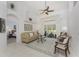 Open living room featuring neutral paint, a ceiling fan, backyard access, and decorative furnishings at 619 Boundary Blvd, Rotonda West, FL 33947