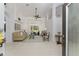 Open living room with neutral paint, a ceiling fan, access to the backyard, and decorative furnishings at 619 Boundary Blvd, Rotonda West, FL 33947