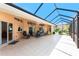Spacious covered patio with tiled floor, providing an ideal outdoor living space at 619 Boundary Blvd, Rotonda West, FL 33947