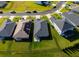 Aerial view of a fenced in backyard and well-maintained home near a pond and neighborhood street at 6315 164Th E Ave, Parrish, FL 34219