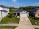Single-story home with lake view, manicured lawn, and a two-car garage on a sunny day at 6315 164Th E Ave, Parrish, FL 34219