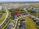 Aerial view of a modern home in a Primary-planned community with a lake and lush landscaping at 6315 164Th E Ave, Parrish, FL 34219