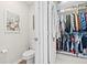 View of walk-in closet and toilet with a decorative art print at 6315 164Th E Ave, Parrish, FL 34219