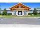 Exterior of the community clubhouse featuring modern architecture, lush landscaping and ample parking at 6315 164Th E Ave, Parrish, FL 34219