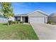 Charming single-story home with well-maintained lawn and a two-car garage on a sunny day at 6315 164Th E Ave, Parrish, FL 34219