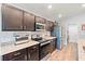 Bright kitchen featuring granite counters, stainless steel appliances, and dark wood cabinetry at 6315 164Th E Ave, Parrish, FL 34219