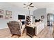 Comfortable living room with neutral paint, ceiling fan, wood-look floors, and natural light at 6315 164Th E Ave, Parrish, FL 34219
