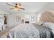 Spacious main bedroom with a plush king bed, ceiling fan, and an attached bathroom at 6315 164Th E Ave, Parrish, FL 34219