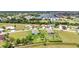 Overhead view of charming homes, golf course ponds, and lush green landscaping in a desirable community at 7028 N Plum Tree, Punta Gorda, FL 33955