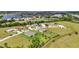 A lovely aerial view showcasing homes with spacious lots, mature trees, and proximity to a serene lake at 7028 N Plum Tree, Punta Gorda, FL 33955