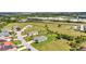 View of a single Gathering home with an attached two car garage with mature trees in a neighborhood at 7028 N Plum Tree, Punta Gorda, FL 33955