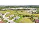 View of a single Gathering home with an attached two car garage with mature trees in a neighborhood at 7028 N Plum Tree, Punta Gorda, FL 33955