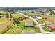 A wide aerial view of a picturesque neighborhood with spacious homes, lush landscaping, and serene surroundings at 7028 N Plum Tree, Punta Gorda, FL 33955