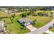 Sprawling single-story home with a 2-car garage, a brick driveway, and a lush, green lawn at 7028 N Plum Tree, Punta Gorda, FL 33955