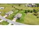 View of a single Gathering home with an attached two car garage with mature trees in a neighborhood at 7028 N Plum Tree, Punta Gorda, FL 33955
