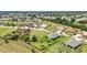 A high-angle view presents a neighborhood with well-maintained properties, lush greenery, and peaceful streets at 7028 N Plum Tree, Punta Gorda, FL 33955