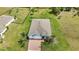 Overhead of a single Gathering house with an attached two car garage with green lawns and mature trees at 7028 N Plum Tree, Punta Gorda, FL 33955