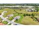 View of a single Gathering home with an attached two car garage with mature trees in a neighborhood at 7028 N Plum Tree, Punta Gorda, FL 33955