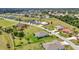 An elevated shot shows a well-planned community with tree-lined streets and meticulously maintained lawns at 7028 N Plum Tree, Punta Gorda, FL 33955