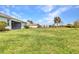 Expansive backyard with lush green grass, mature landscaping, and fenced perimeter at 7028 N Plum Tree, Punta Gorda, FL 33955
