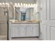 Bright bathroom has a double sink vanity with granite counters and modern lighting at 7028 N Plum Tree, Punta Gorda, FL 33955