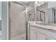 Tiled bathroom with glass shower, granite vanity, and a large mirror at 7028 N Plum Tree, Punta Gorda, FL 33955