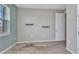 Neutral carpeted bedroom features floating shelves and two windows with blindsl at 7028 N Plum Tree, Punta Gorda, FL 33955