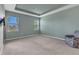 Bright bedroom features a tray ceiling, two windows, and neutral carpet at 7028 N Plum Tree, Punta Gorda, FL 33955