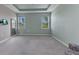 Carpeted bedroom with a tray ceiling and two windows for natural light at 7028 N Plum Tree, Punta Gorda, FL 33955