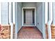 Front door with brick trim and sidelights, and covered entrance at 7028 N Plum Tree, Punta Gorda, FL 33955