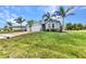Charming blue home with a well-manicured lawn, brick-paved driveway, and a two-car garage at 7028 N Plum Tree, Punta Gorda, FL 33955