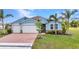 Charming single-Gathering home with a two-car garage, brick paver driveway, and lush landscaping at 7028 N Plum Tree, Punta Gorda, FL 33955