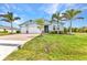 Charming blue home with a well-manicured lawn, brick-paved driveway, and a two-car garage at 7028 N Plum Tree, Punta Gorda, FL 33955